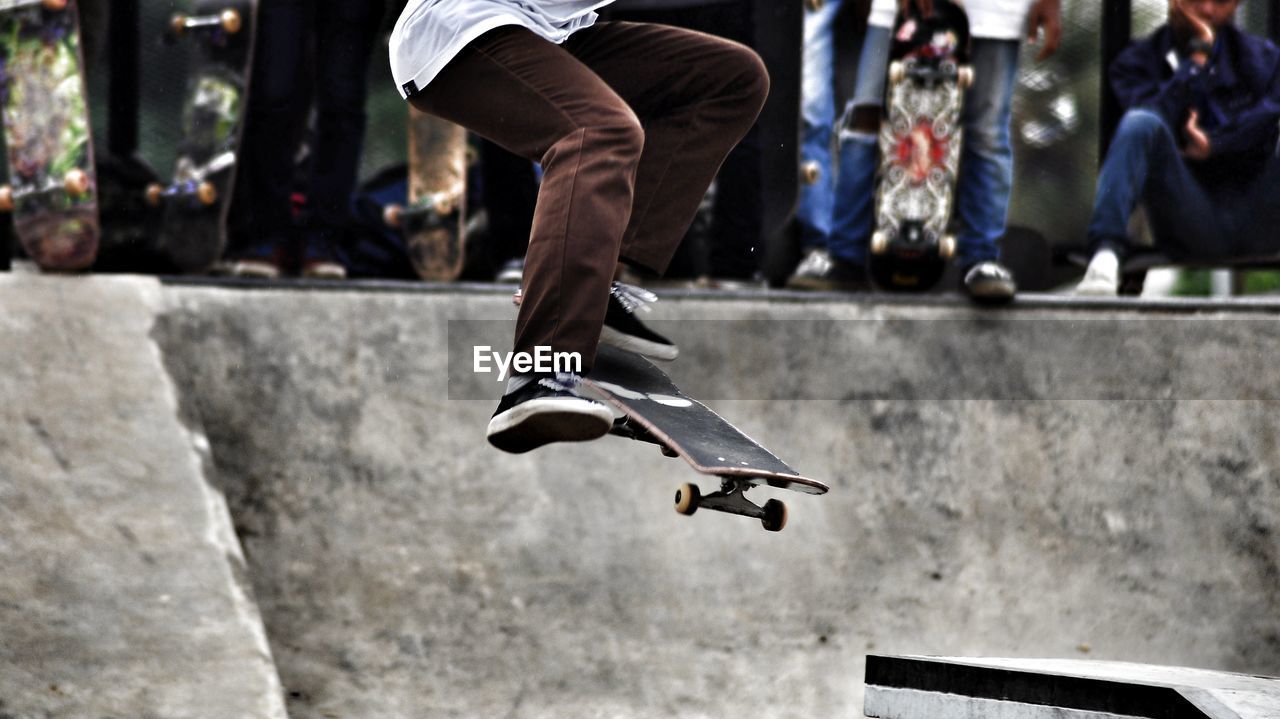 Low section of man skateboarding at playground