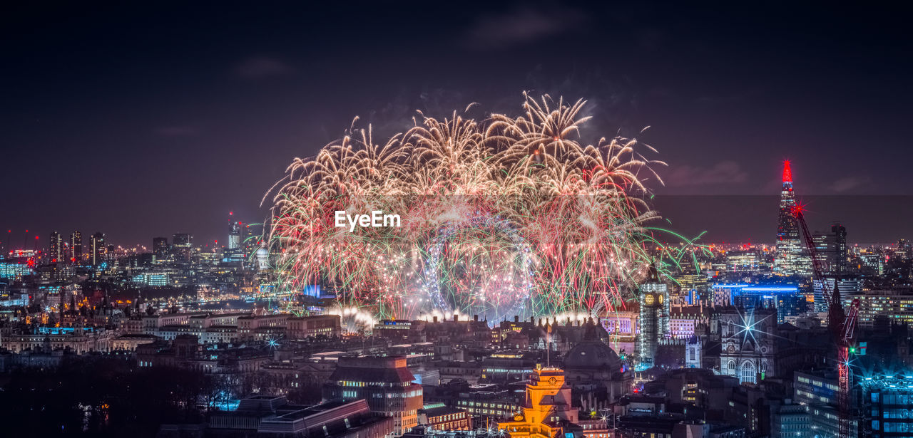 High angle view of firework display at night