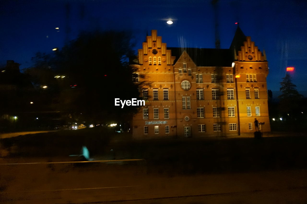 VIEW OF ILLUMINATED BUILDINGS AT NIGHT