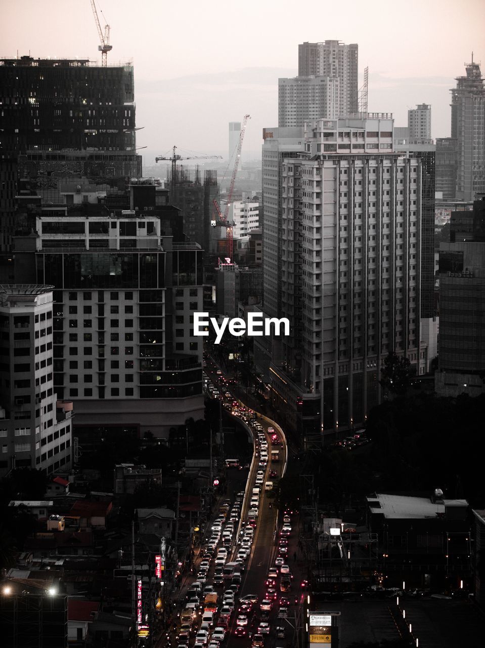 HIGH ANGLE VIEW OF TRAFFIC ON ROAD BY BUILDINGS