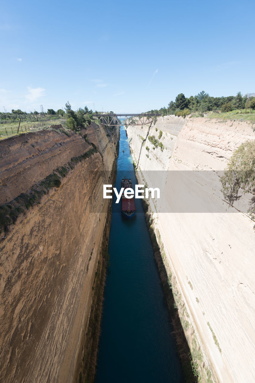 High angle view of river amidst land against sky