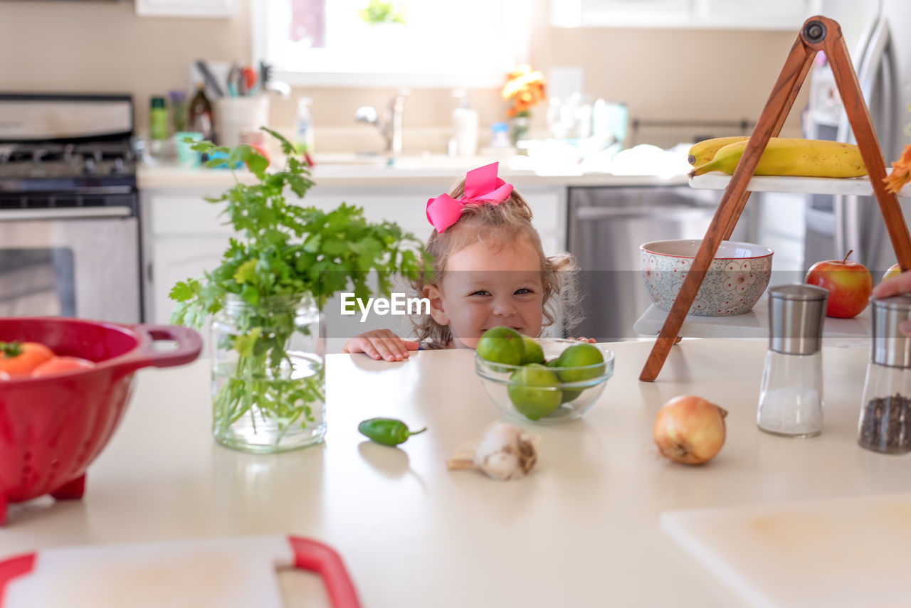 VARIOUS FOOD ON TABLE IN KITCHEN