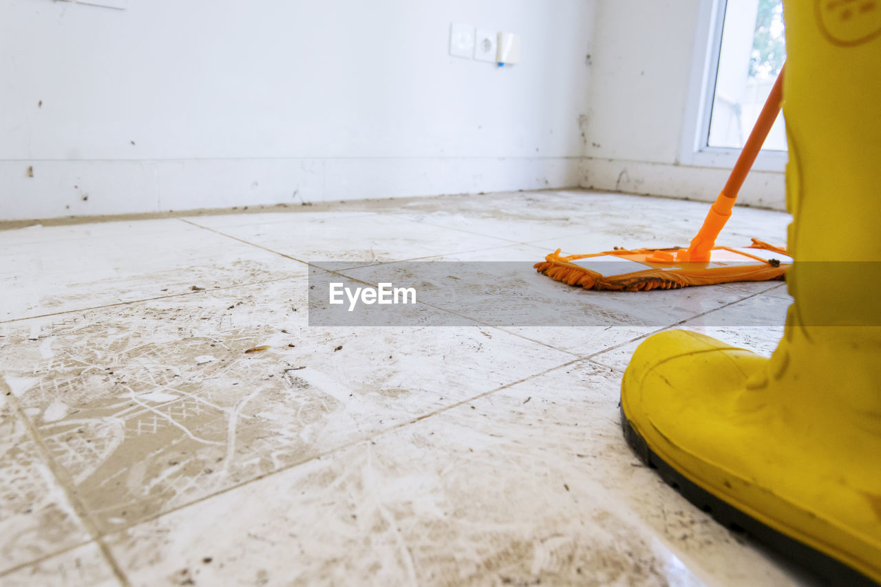 YELLOW UMBRELLA ON TILED FLOOR