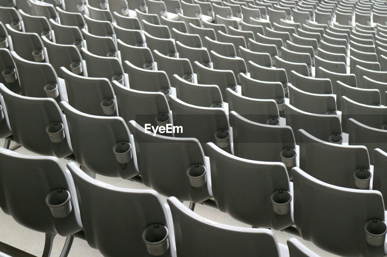 Full frame shot of empty white seats at soccer stadium