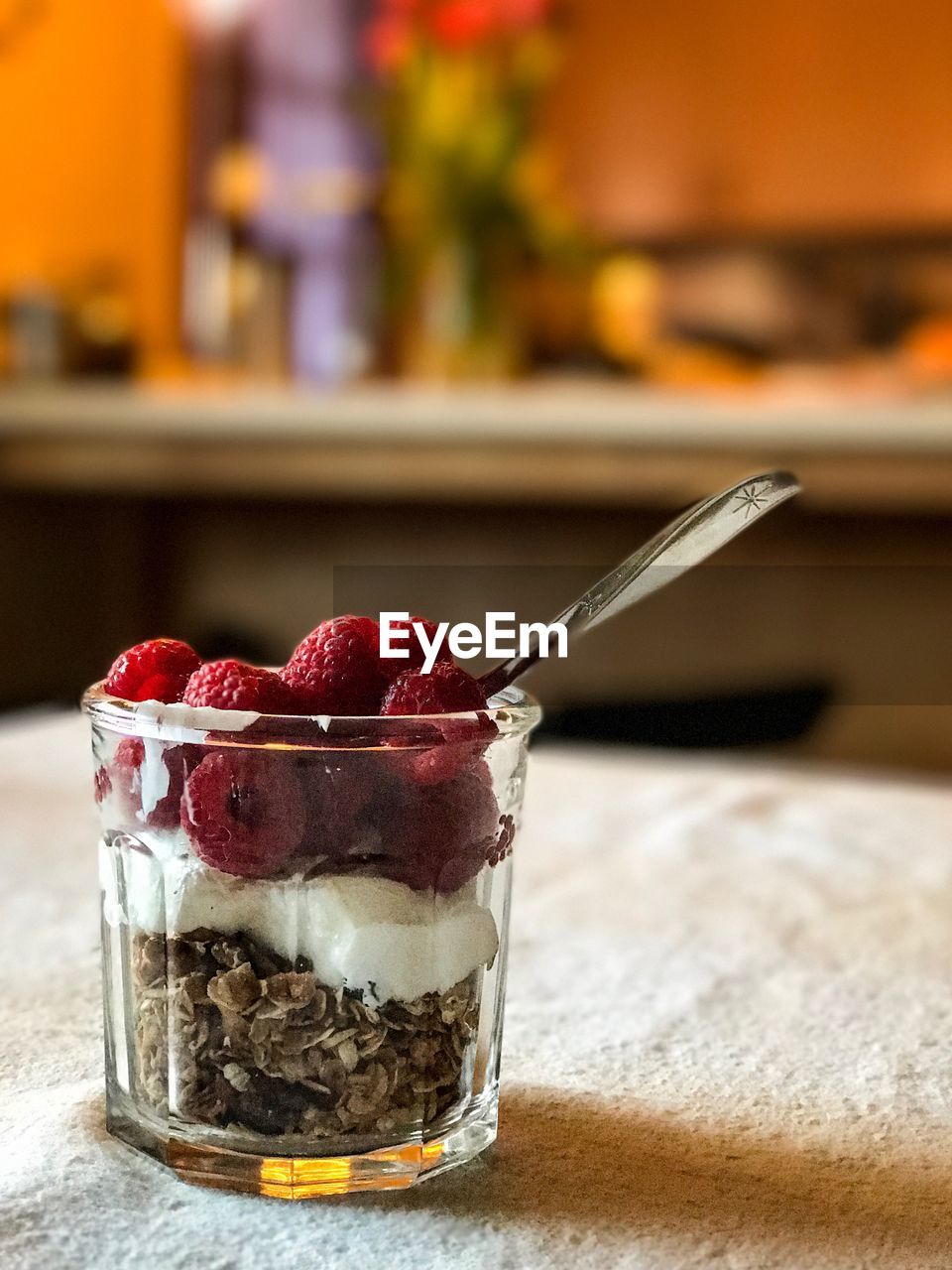 CLOSE-UP OF ICE CREAM IN GLASS WITH SPOON