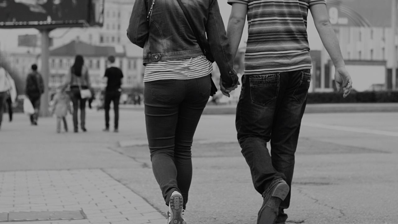 Couple holding hands on street