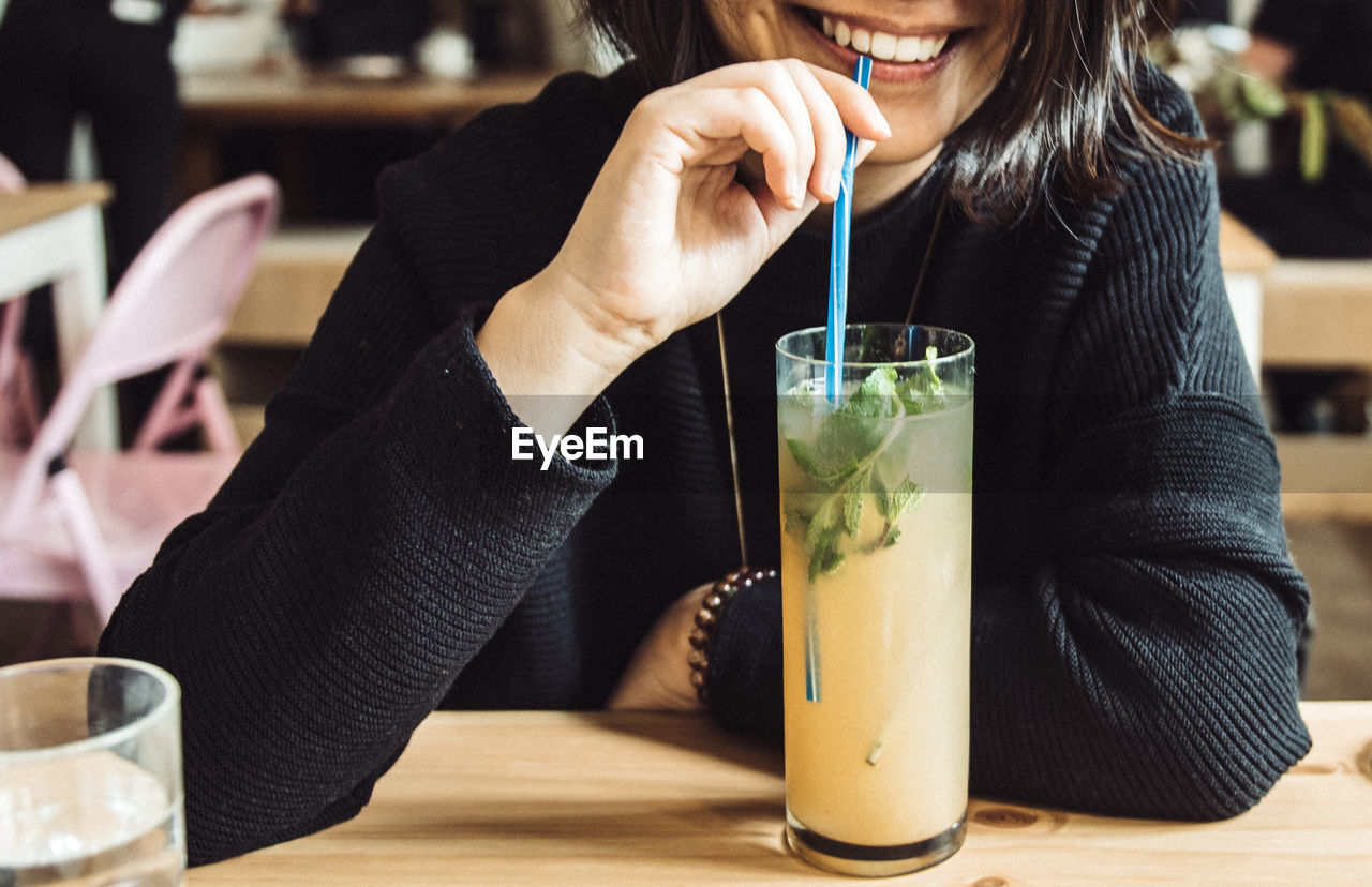 Close-up of woman drinking cocktail