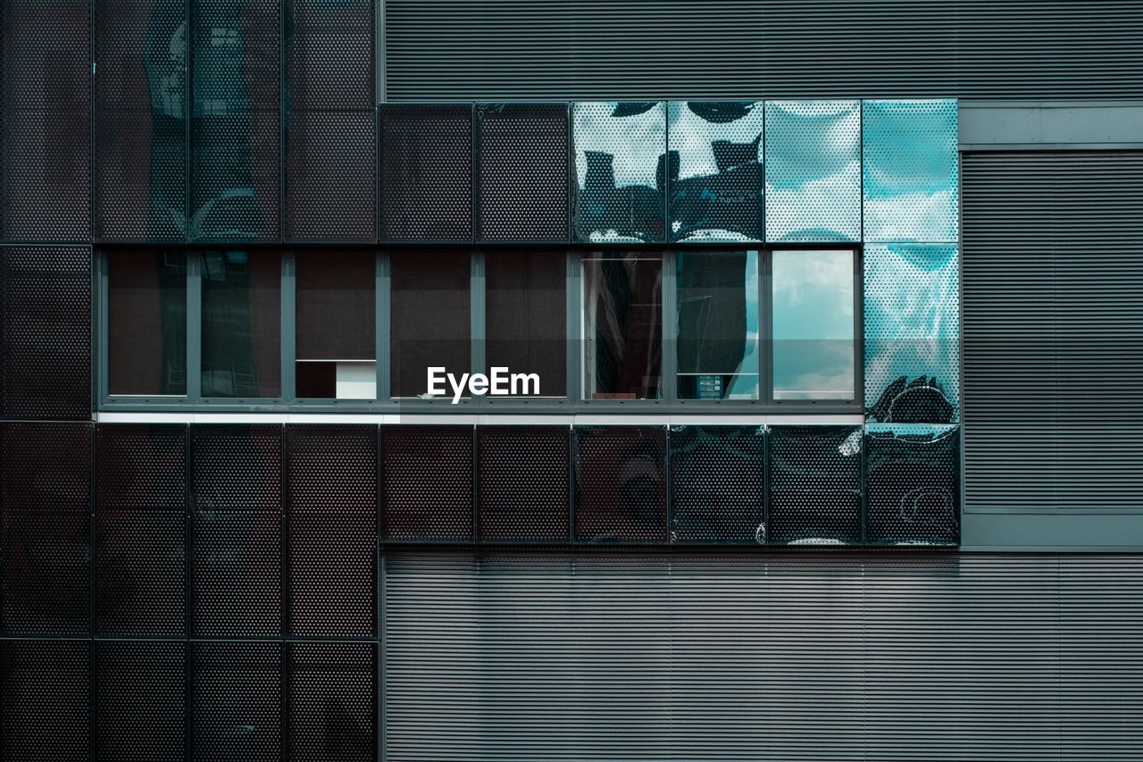 Low angle view of glass window of building