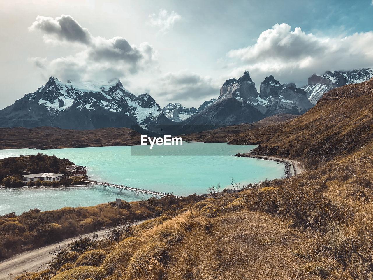 Wide angle shot of lake in front of famous torres del paine ridge line