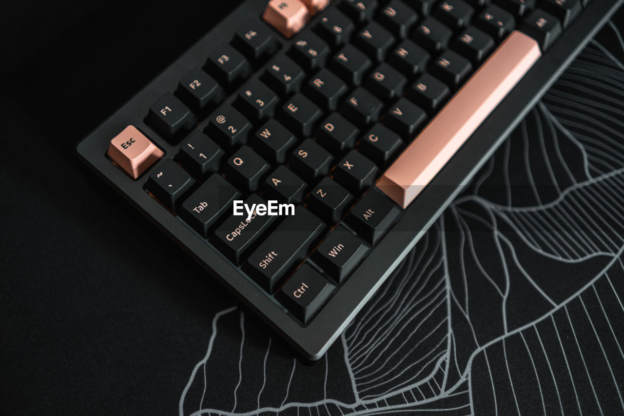 Close-up of custom mechanical computer keyboard, 75 percent layout, olivia keycaps