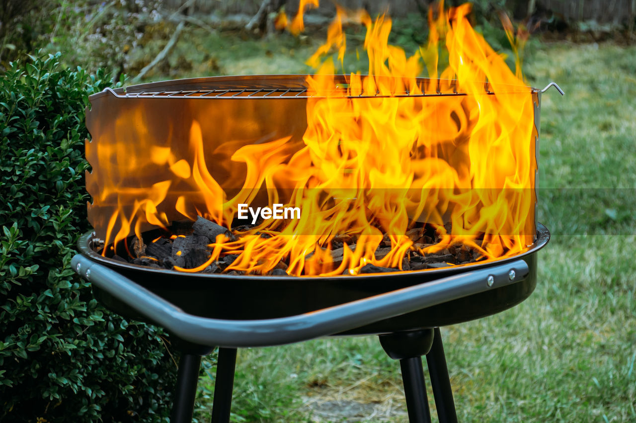 Close-up of yellow fire on grill