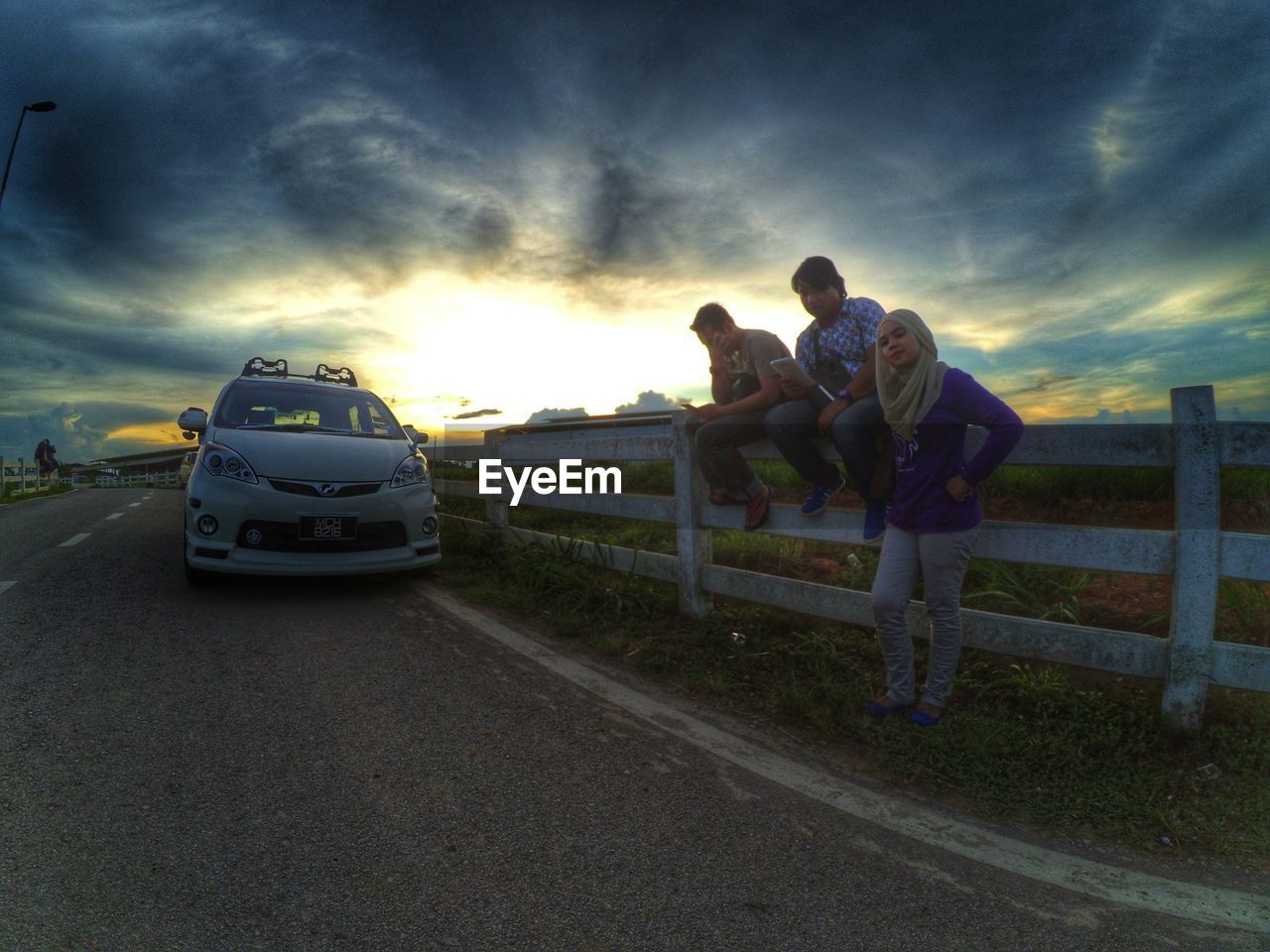 PEOPLE ON ROAD AT SUNSET