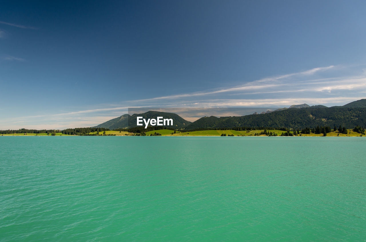 Scenic view of sea against blue sky