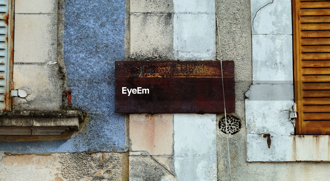 Low angle view of wooden plank on wall