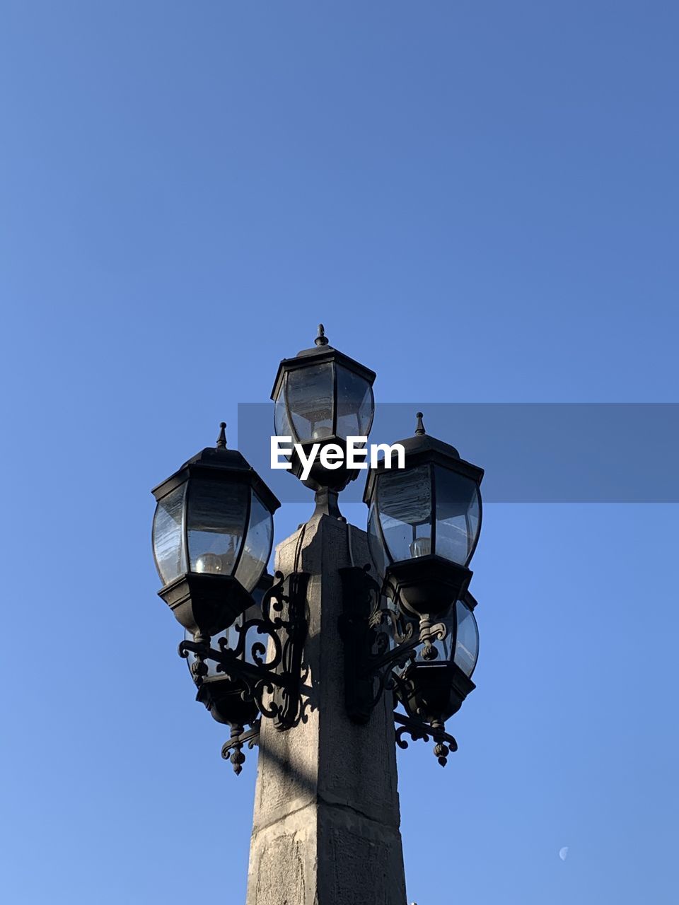 Low angle view of street light against clear blue sky