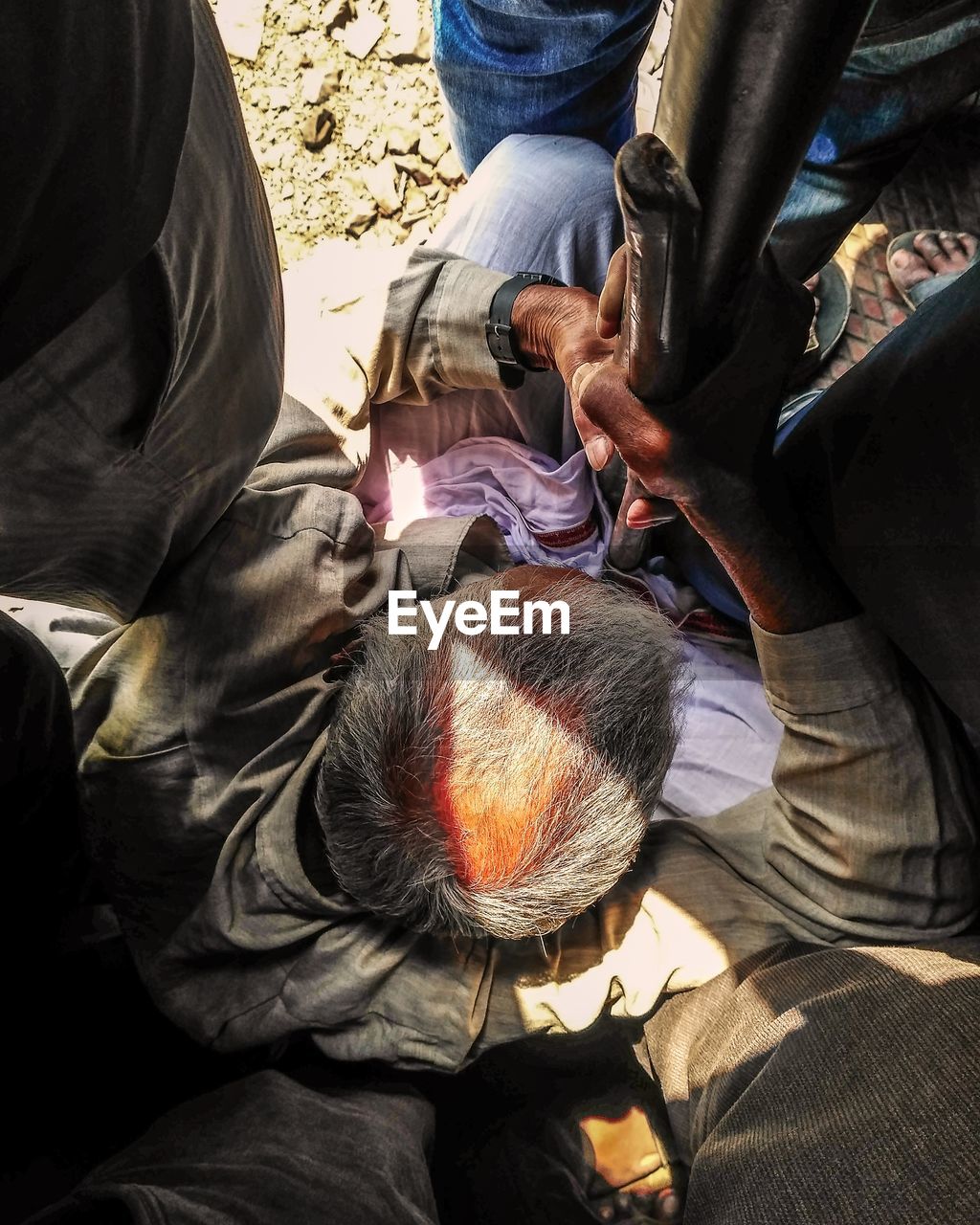 Senior man sitting in train on sunny day