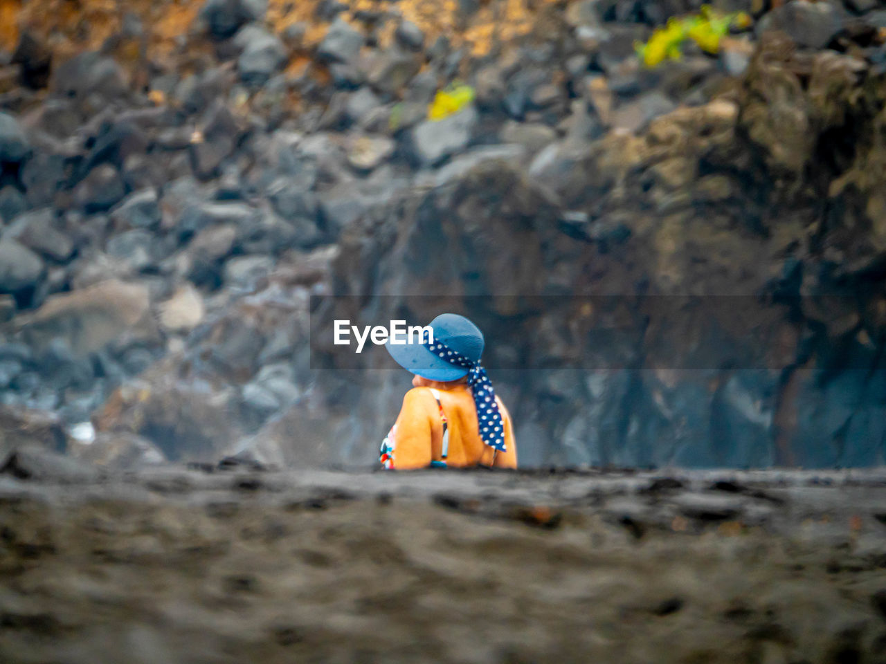 BOY TOY ON ROCK AT LAND