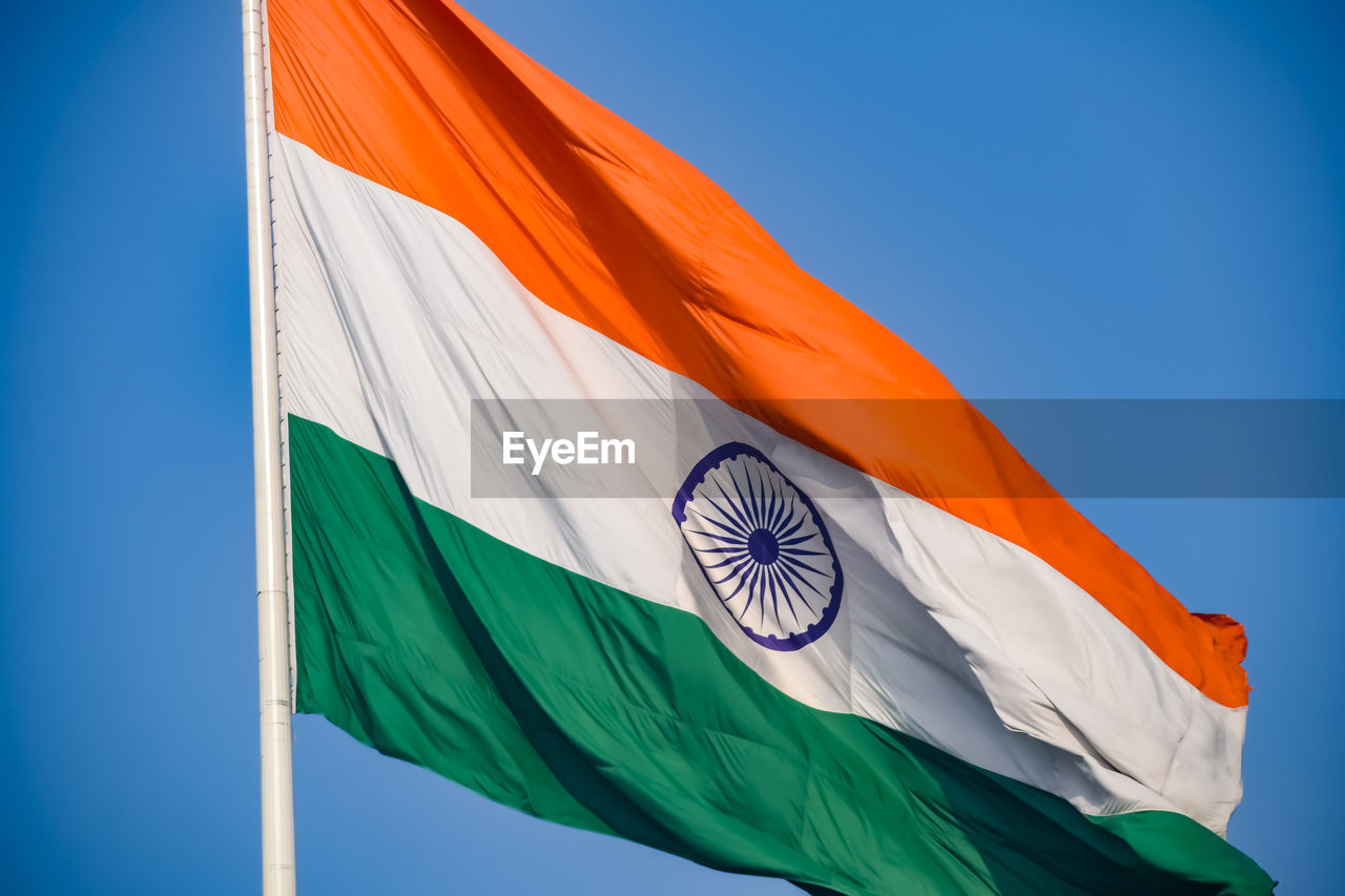 India flag flying high at connaught place with pride in blue sky, india flag fluttering, indian flag