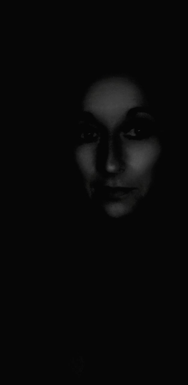 Portrait of mature woman in darkroom