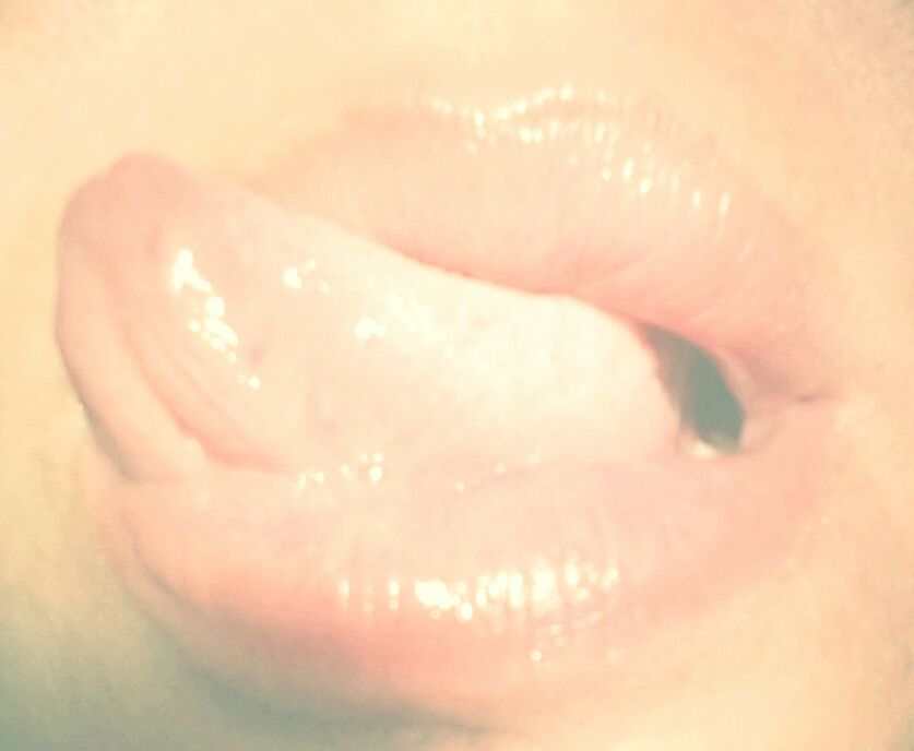 Cropped image of woman sticking out tongue