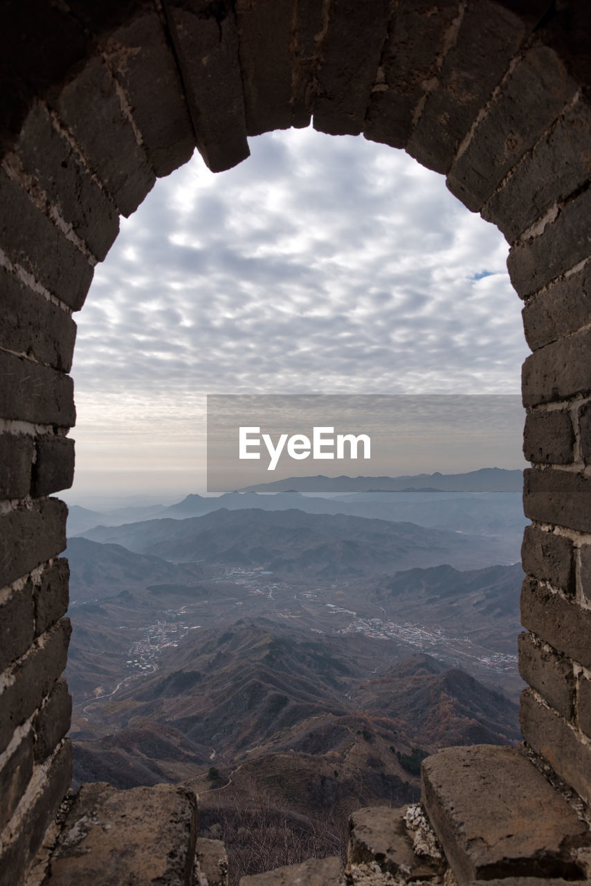 Scenic view of mountains against cloudy sky