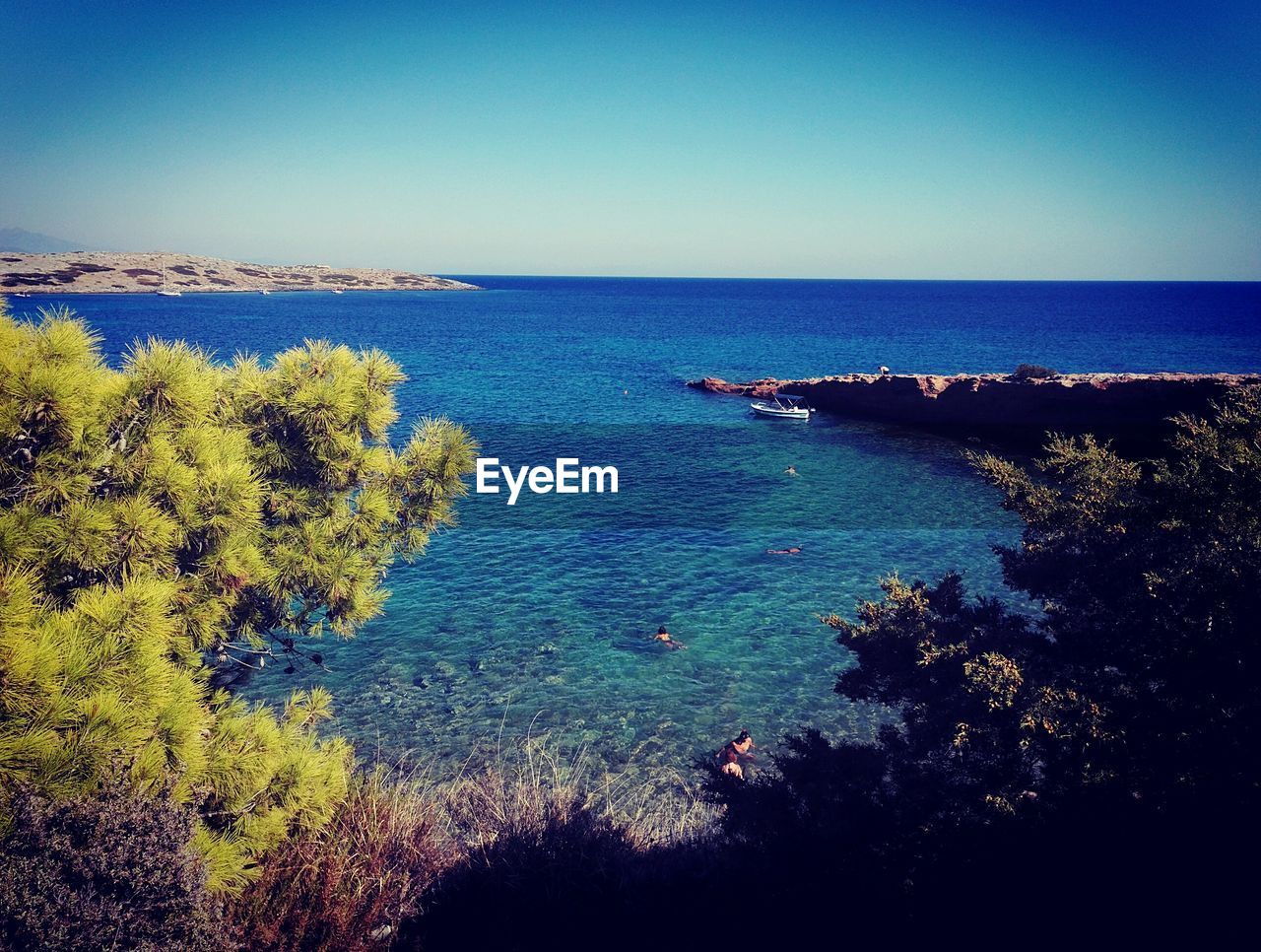 SCENIC VIEW OF BAY AGAINST CLEAR BLUE SKY