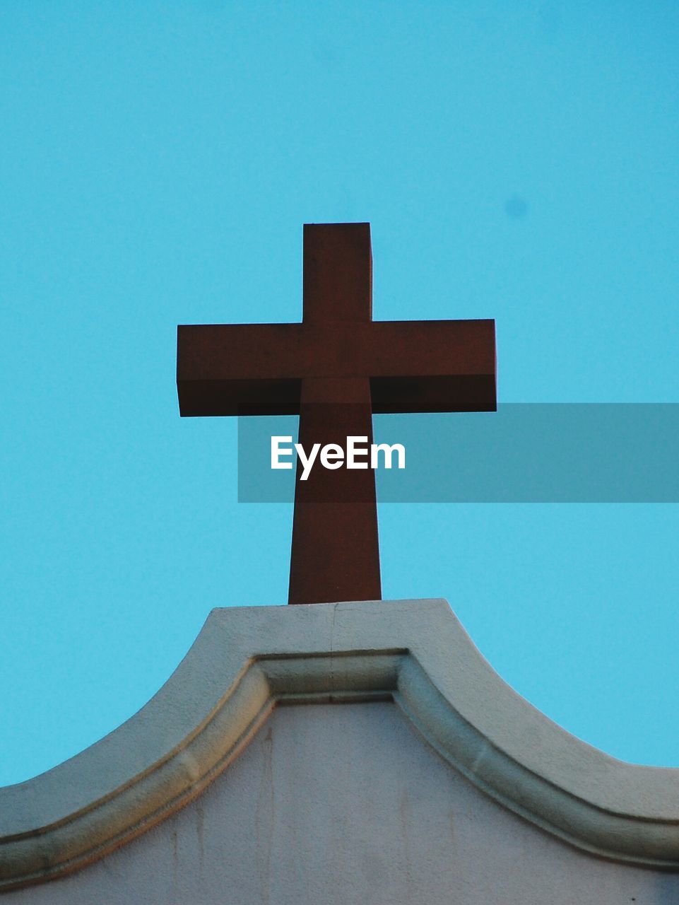 Low angle view of cross on church against clear sky