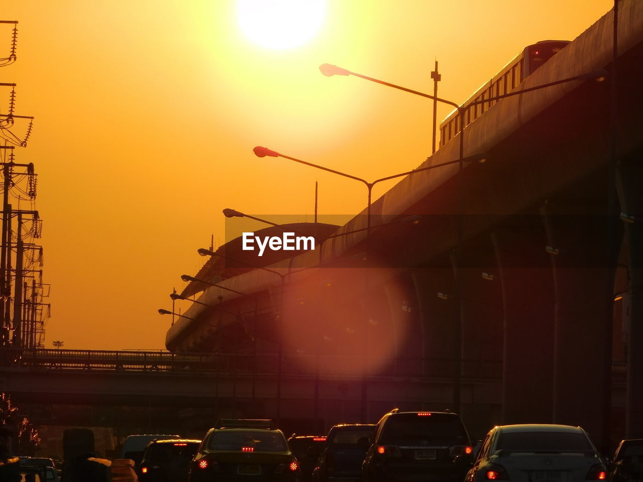 VEHICLES ON STREET AT SUNSET