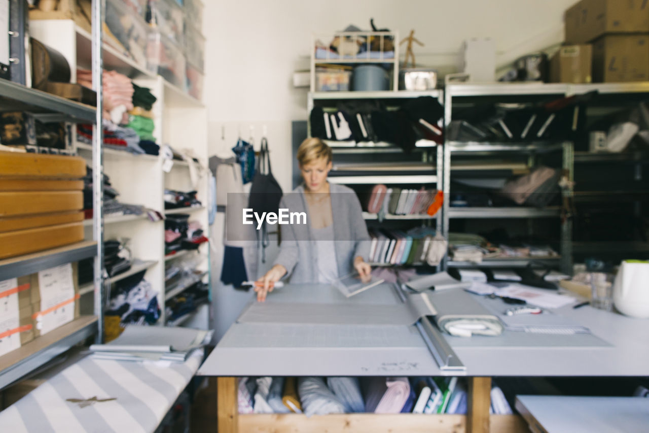 Fashion designer working on template in studio