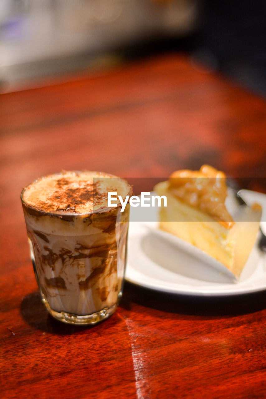 CLOSE-UP OF COFFEE WITH DRINK ON TABLE