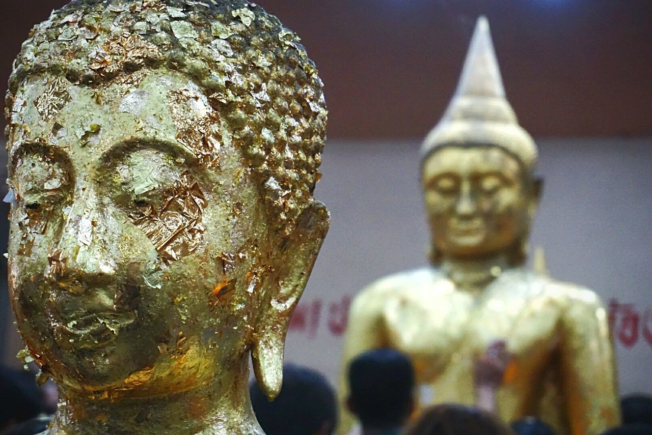 CLOSE-UP OF STATUE AGAINST TEMPLE