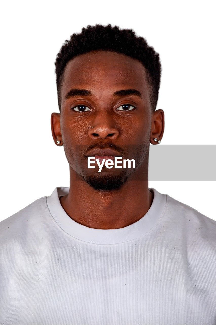 portrait, hairstyle, one person, human hair, studio shot, white background, headshot, indoors, adult, looking at camera, young adult, casual clothing, men, front view, facial hair, moustache, cut out, emotion, person, t-shirt, serious, relaxation, black hair, individuality, white, afro, human face, looking, human head, short hair, curly hair, shaved head, brown eyes