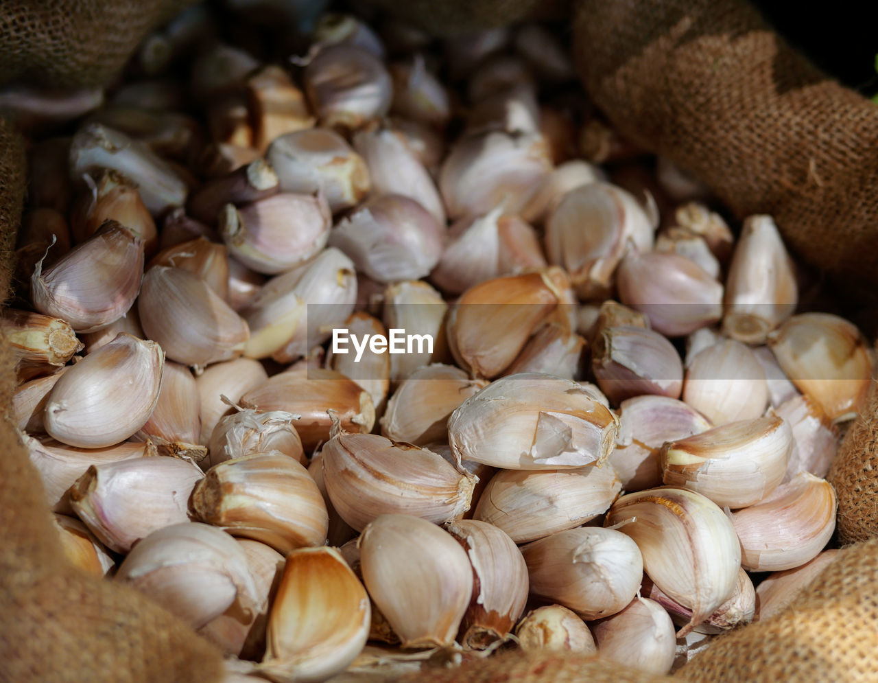 CLOSE-UP OF ONIONS FOR SALE AT MARKET STALL