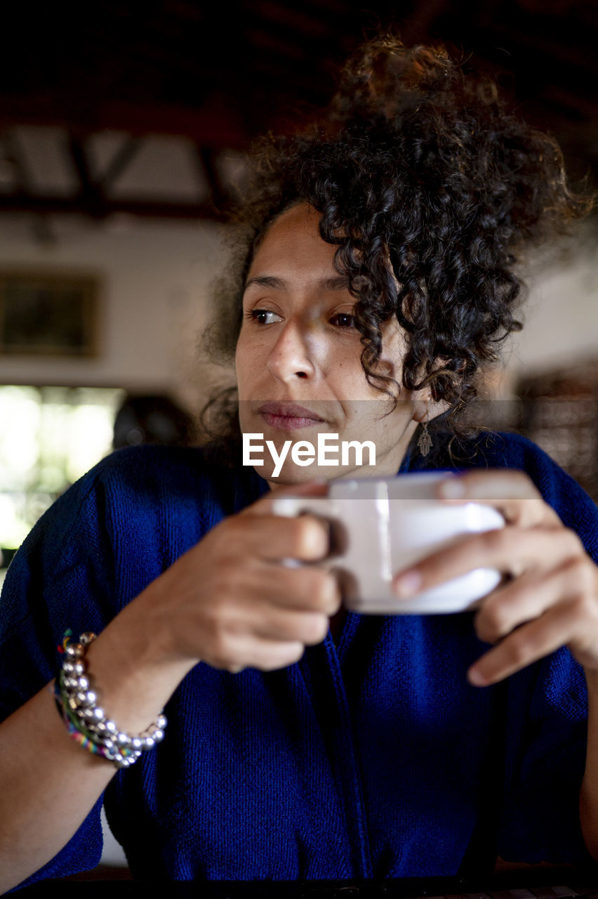 Relaxed woman drinking a cup of coffee,