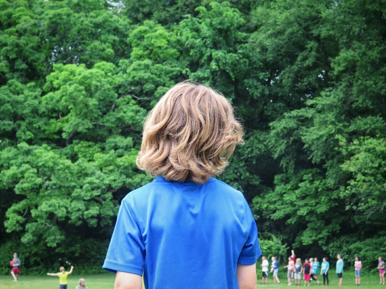 Children at playground against trees