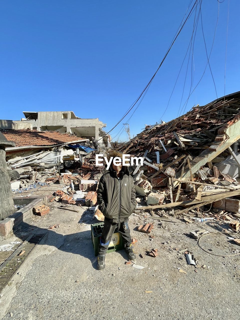 sky, earthquake, nature, architecture, clear sky, one person, men, day, blue, occupation, built structure, full length, adult, sunlight, transportation, outdoors, sunny, industry, working, building exterior, land, rubble