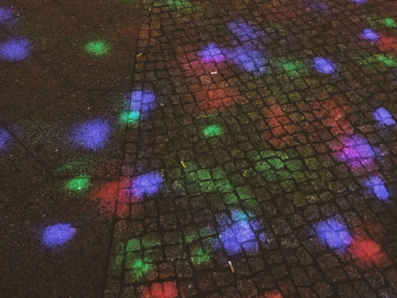 Colored light spots on pavement