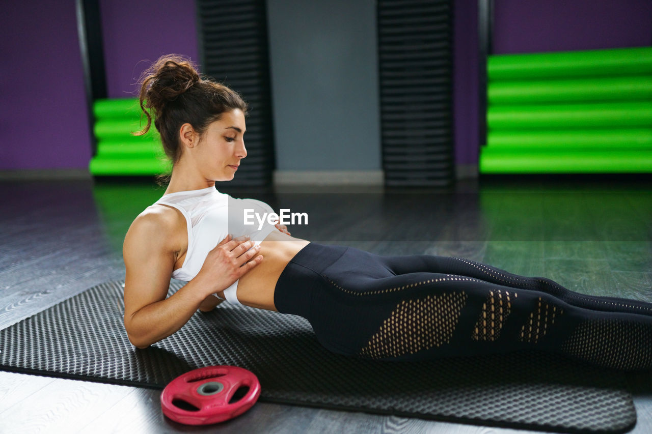 Young woman exercising at gym