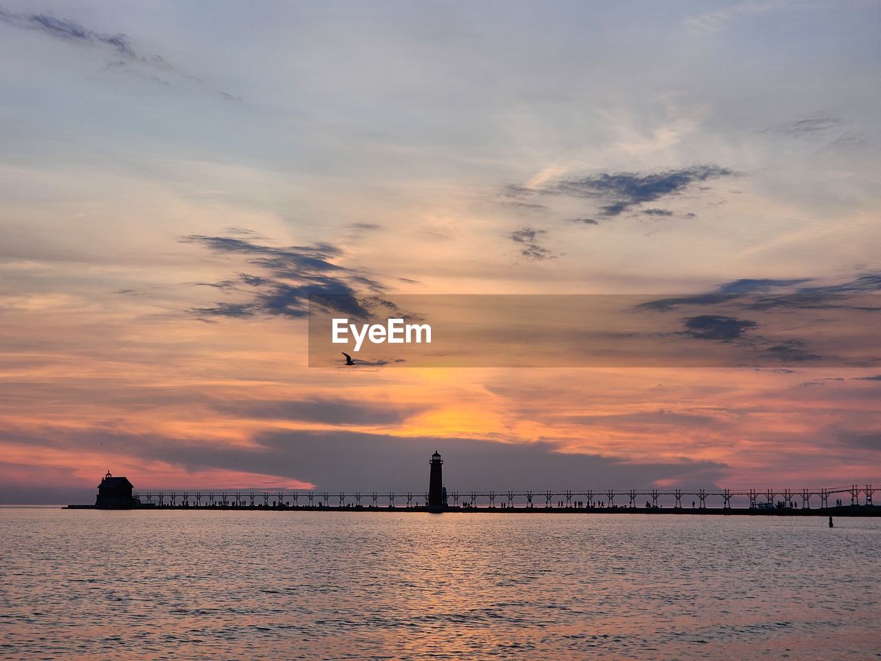 sky, cloud, horizon, water, sunset, dawn, sea, architecture, nature, beauty in nature, built structure, ocean, evening, reflection, scenics - nature, travel destinations, bird, silhouette, afterglow, no people, tranquility, animal themes, animal, transportation, building exterior, dramatic sky, coast, outdoors, tranquil scene, travel, shore, city, sunlight, wildlife, landscape, beach, environment, animal wildlife, flying, idyllic, sun, land, tourism, building