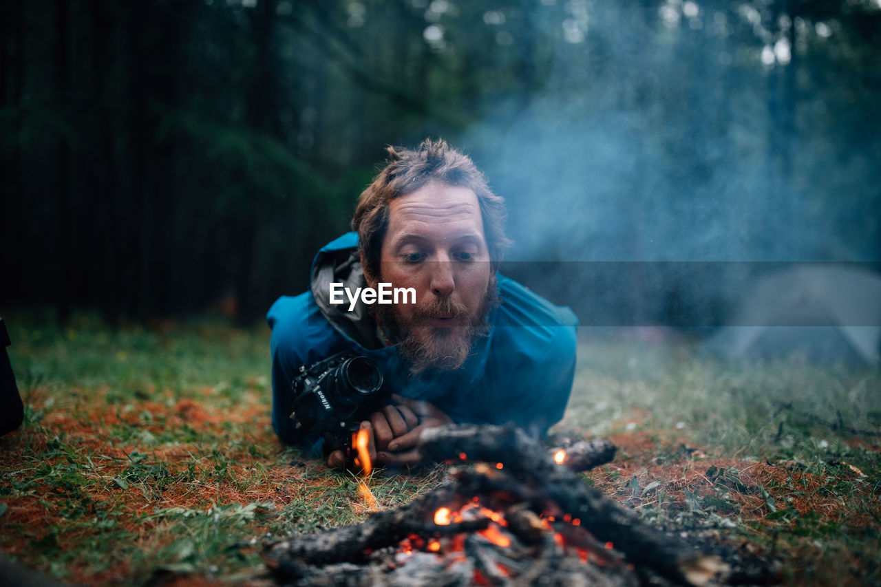 PORTRAIT OF YOUNG MAN IN FOREST