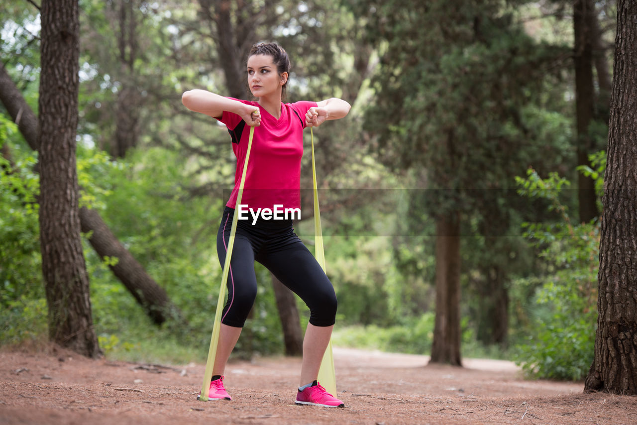 full length of young man exercising on road