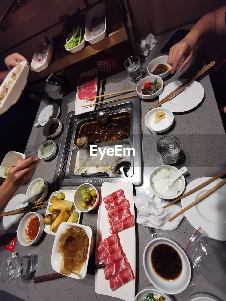 HIGH ANGLE VIEW OF PEOPLE PREPARING FOOD