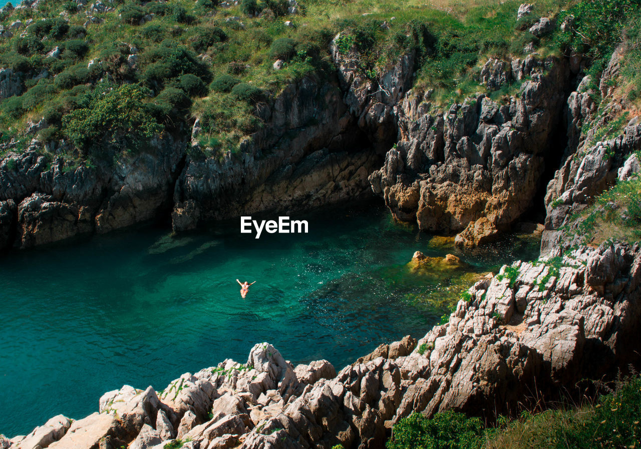 Distant view of woman swimming in sea