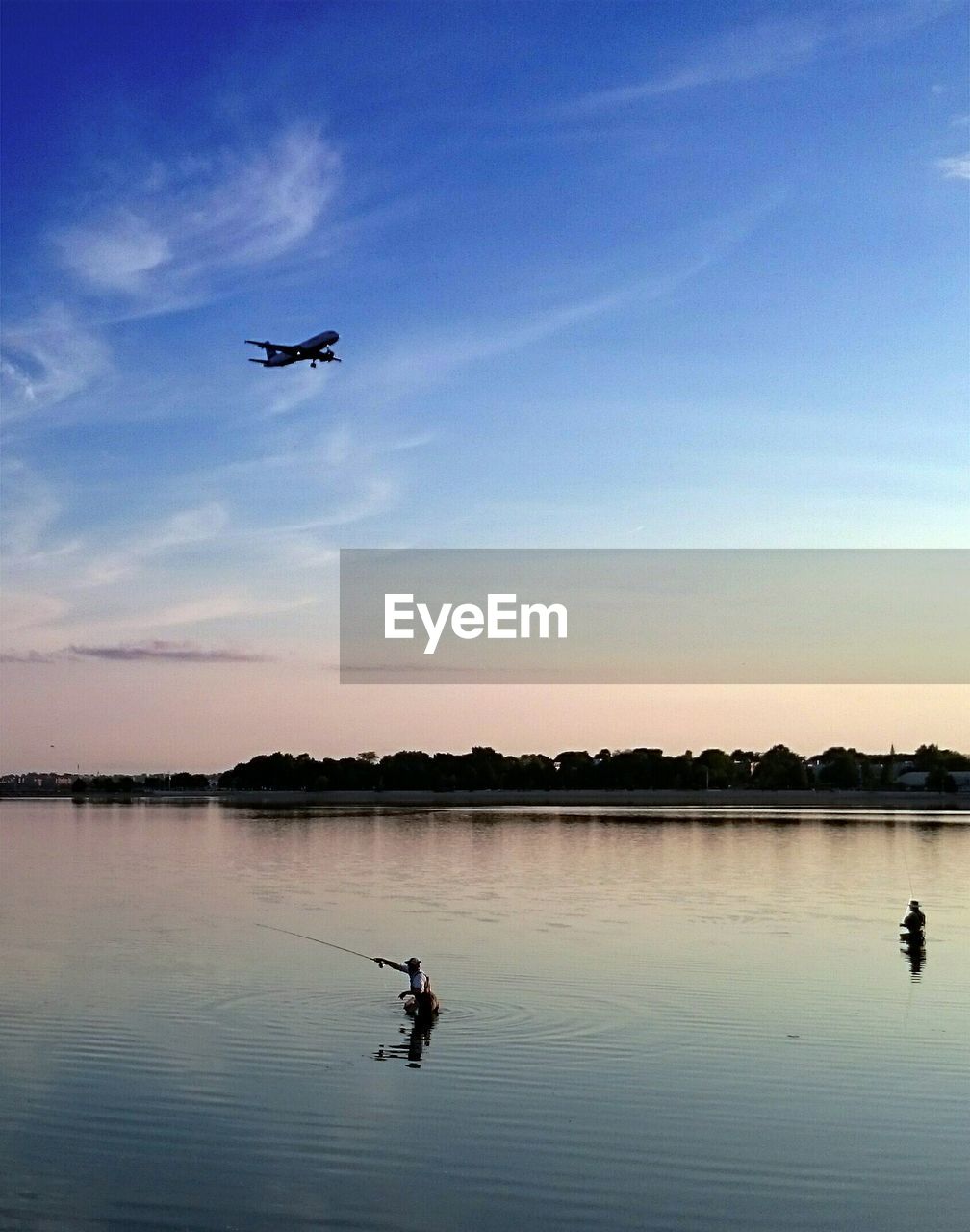 Airplane in flight over calm sea