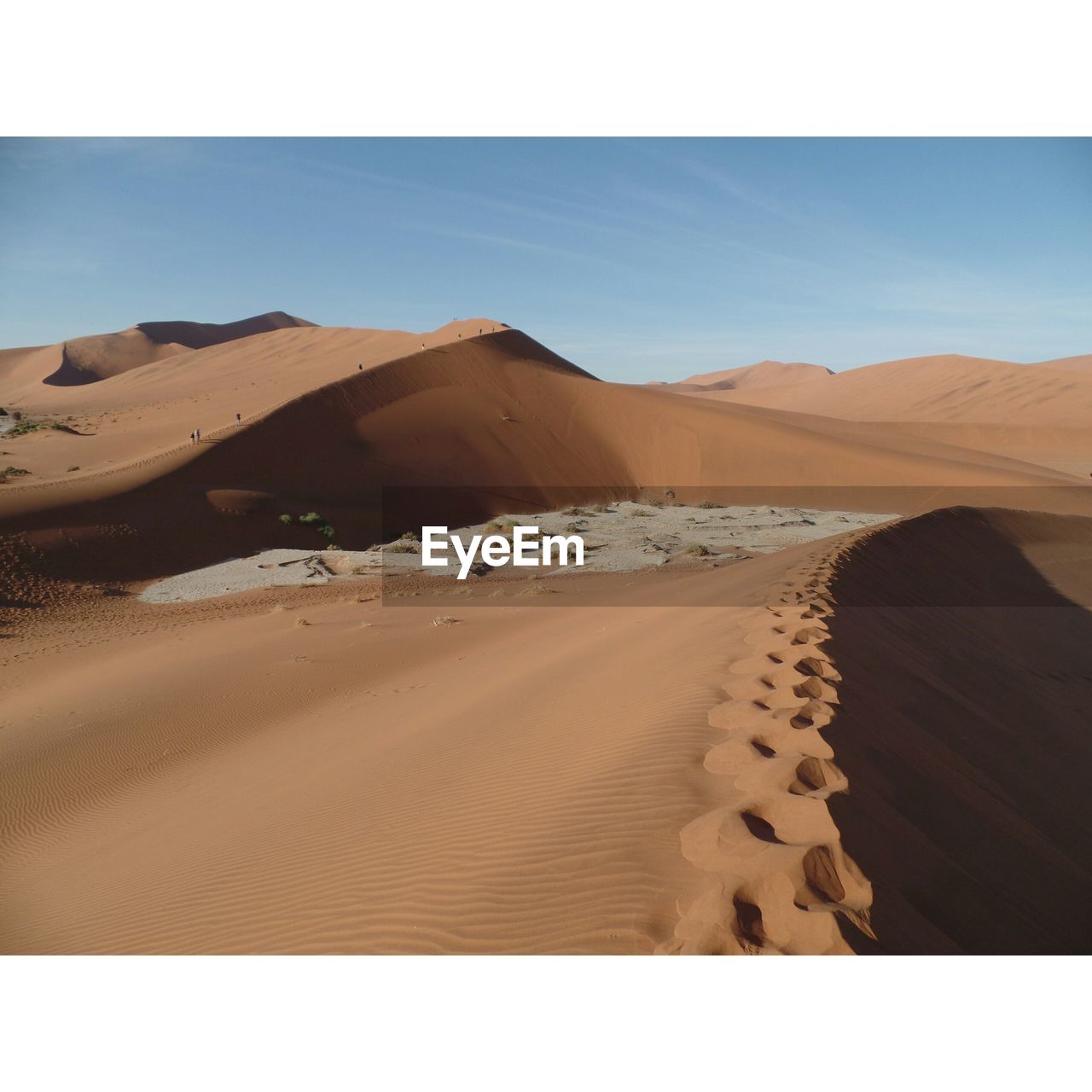 Sand dunes at namibian desert against sky