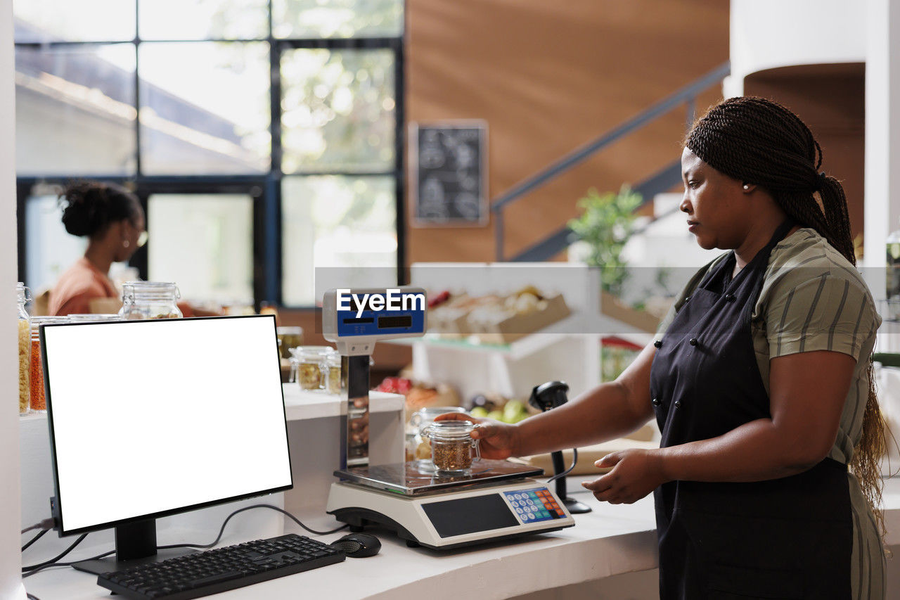 side view of man using laptop at cafe