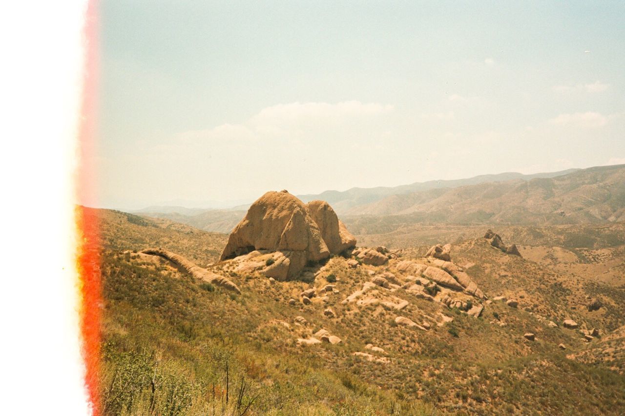 View of landscape with mountain range in the background