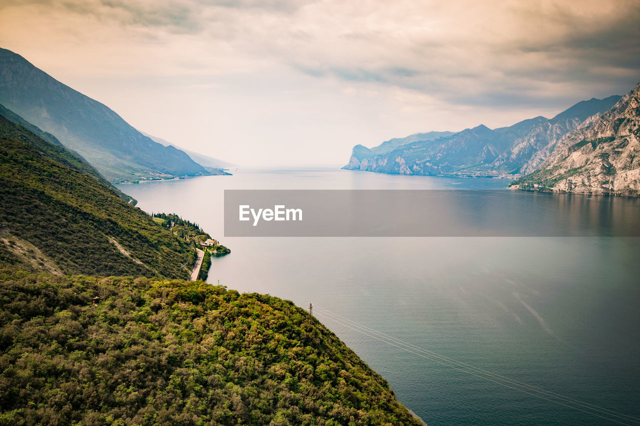 Scenic view of lake by mountains against sky