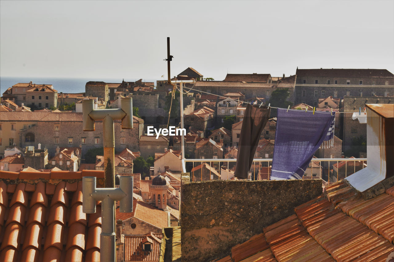 Buildings in city against clear sky