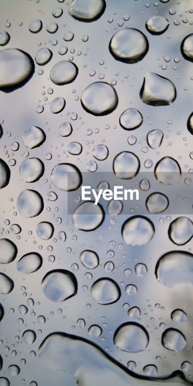 Full frame shot of raindrops on glass